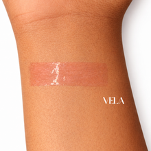 Load image into Gallery viewer, Lip gloss swatch on a wrist with 'VELA' after dark lipgloss

